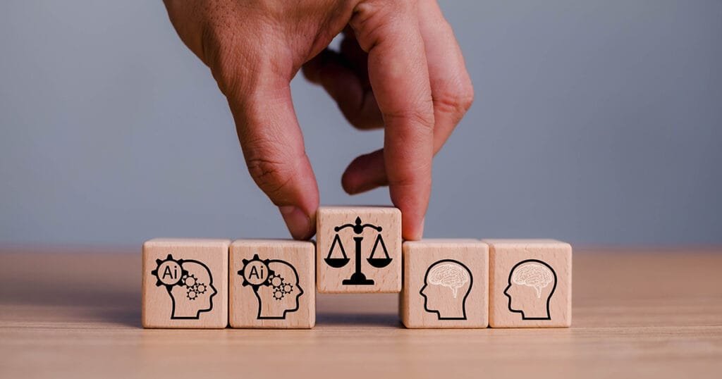 A mans hand holding a small wooden block with a picture of balanced scales imprinted on it to show the importance of ethics in generative AI for small charities