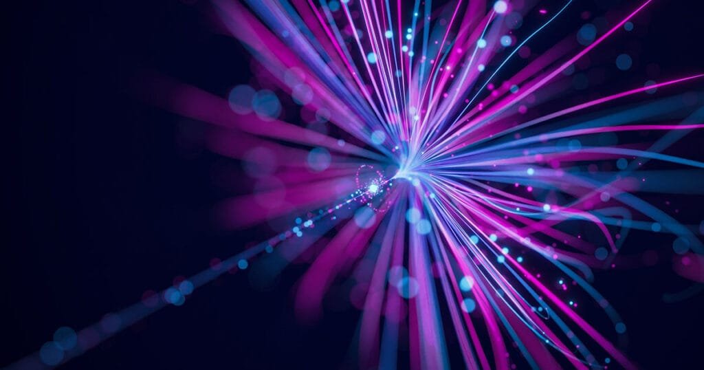 Bright, abstract burst of pink and blue light trails on a dark background, symbolizing the future potential and expansion of neural network technology.